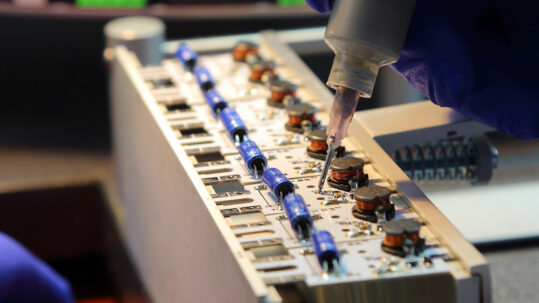 Technician working on an electronic circuit board