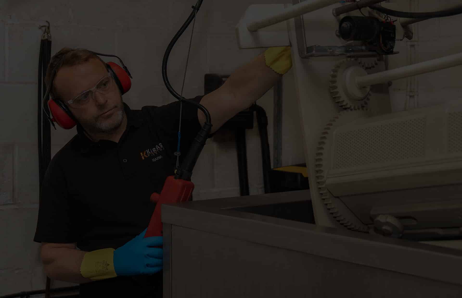 A Karas Plating employee using machinery to electroplate metal