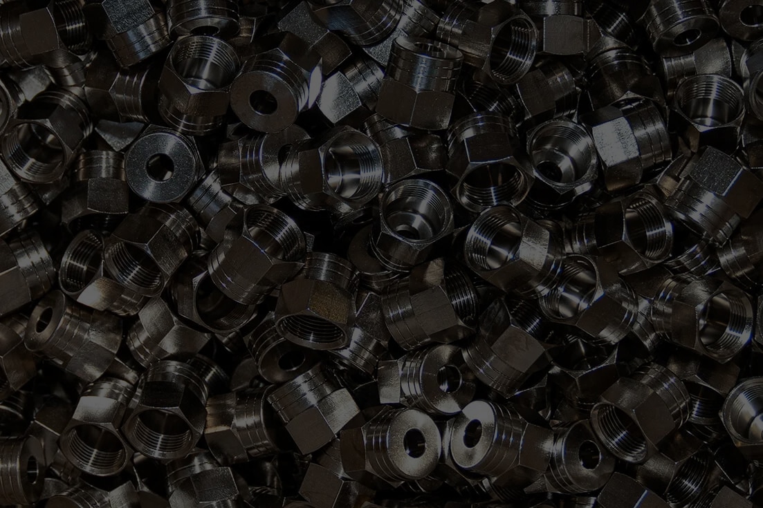Pile of electroplated threaded steel fittings