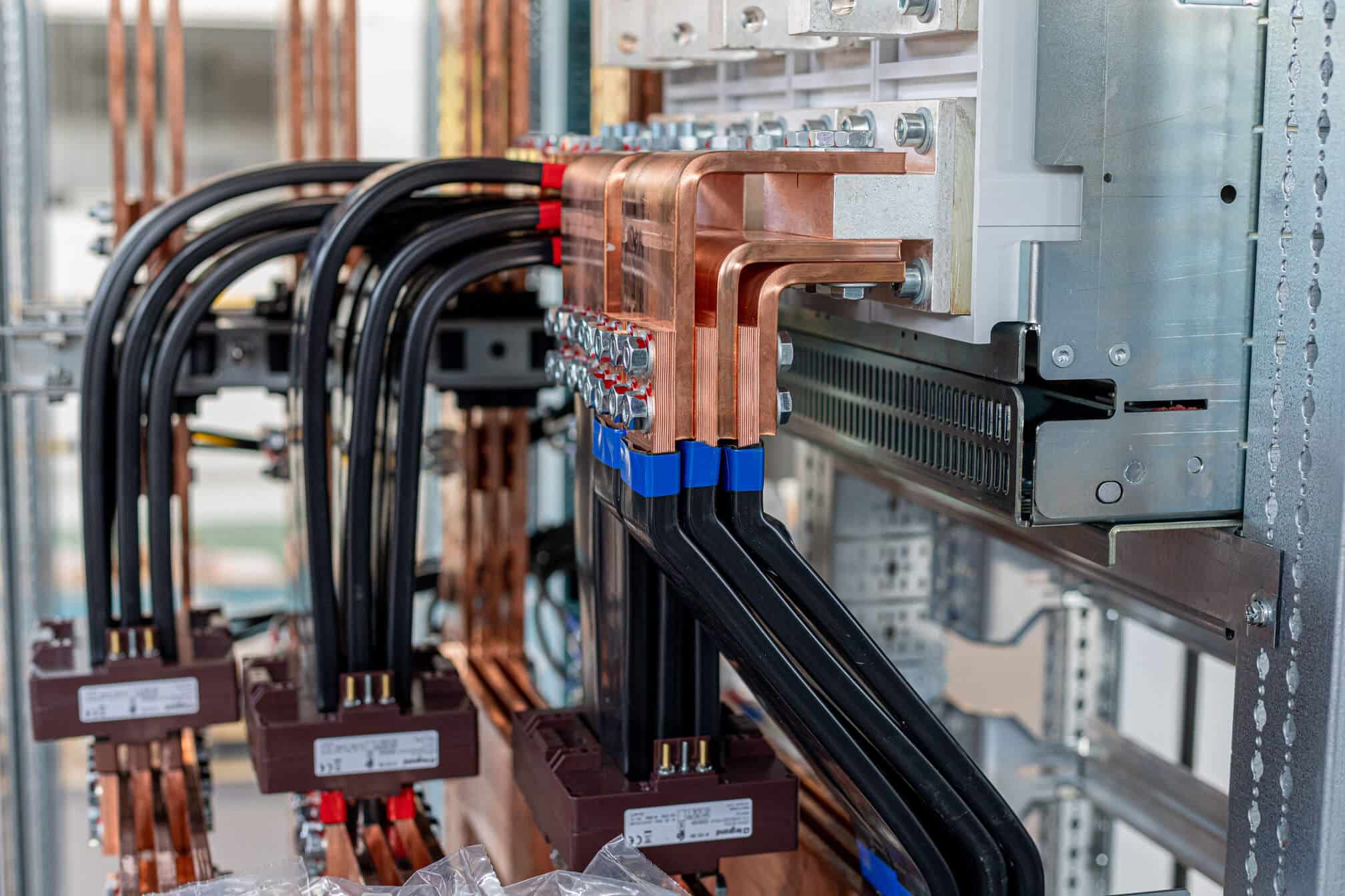 Copper busbars and flexible cable connections in an electrical switchboard