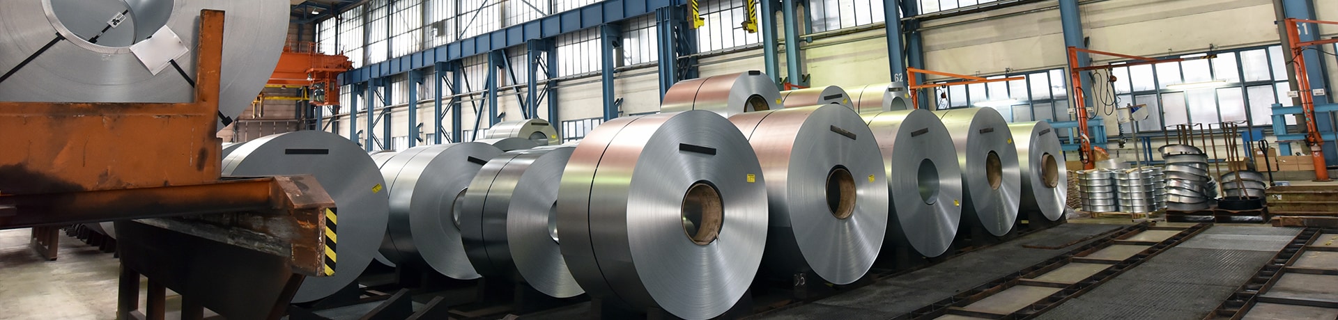 Big circular metal blocks lined up in a factory