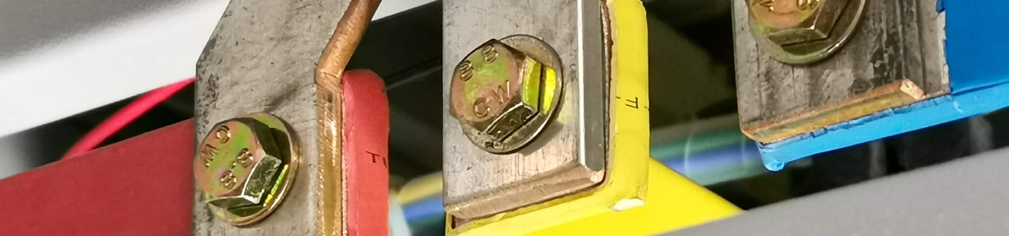 Busbar connection inside an electrical panel or distribution system.