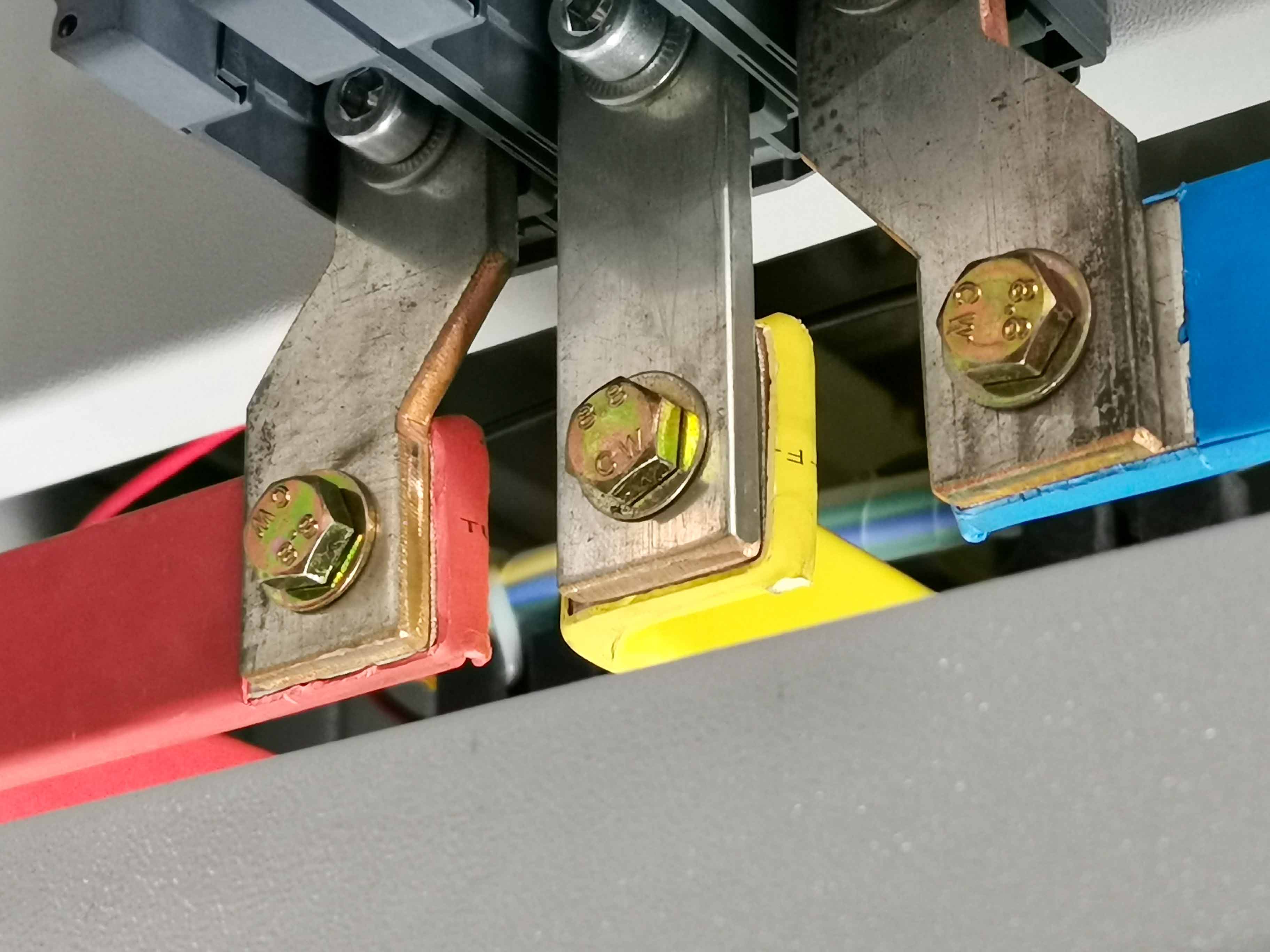 Busbar connection inside an electrical panel or distribution system.